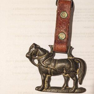 Vintage brass horse with leather strap